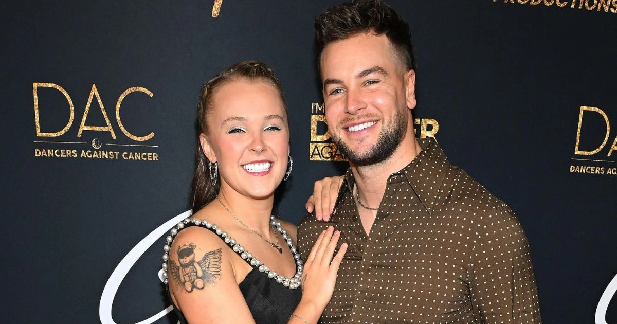 JoJo Siwa and Chris Hughes share passionate on-stage kiss in L.A. as he teases potential engagement